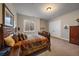 Cozy bedroom with a basement window, wood furniture, and neutral color palette at 5069 Castle Pines S Dr, Castle Rock, CO 80108