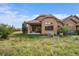 Charming exterior elevation featuring stone accents and professionally landscaped yard at 5069 Castle Pines S Dr, Castle Rock, CO 80108