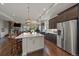 The open floor plan connects the kitchen to a cozy fireplace in the living area for comfortable living at 5069 Castle Pines S Dr, Castle Rock, CO 80108