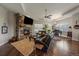 Open concept living room with stone fireplace and ample natural light at 5069 Castle Pines S Dr, Castle Rock, CO 80108