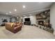 Open living room featuring a stone fireplace, TV, and comfortable seating area at 5069 Castle Pines S Dr, Castle Rock, CO 80108