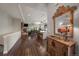 Cozy living room and kitchen featuring a stone fireplace and wood floors at 5069 Castle Pines S Dr, Castle Rock, CO 80108