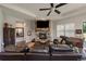 Cozy living room with a stone fireplace, a large television, and comfortable leather seating at 5069 Castle Pines S Dr, Castle Rock, CO 80108