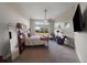 Bright and spacious main bedroom featuring large windows, ceiling fan, and comfortable seating area at 5069 Castle Pines S Dr, Castle Rock, CO 80108
