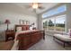 Sun-filled main bedroom with a large window view and an elegant, comfortable bed at 5069 Castle Pines S Dr, Castle Rock, CO 80108