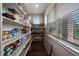 Well-organized pantry with shelving and plenty of storage space to keep your kitchen clutter-free at 5069 Castle Pines S Dr, Castle Rock, CO 80108