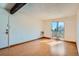 A bright living room has a beamed ceiling and access to a balcony at 16259 W 10Th Ave # J5, Golden, CO 80401