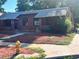 Quaint brick duplex with individual entrances, red mulch and mature landscaping at 292 S Lafayette St, Denver, CO 80209