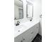 Bathroom featuring double vanity with modern fixtures, mirrors, and dark floors at 10330 E Jewell Ave # 67, Aurora, CO 80247