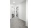 Bedroom leading to a bathroom and closet, with neutral carpet and white walls at 10330 E Jewell Ave # 67, Aurora, CO 80247