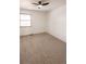 This bedroom features neutral carpet, a window with natural light, and a ceiling fan at 10330 E Jewell Ave # 67, Aurora, CO 80247