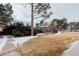 Exterior shot of a grey building with a pool behind it and a large yard and tree at 10330 E Jewell Ave # 67, Aurora, CO 80247