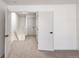 Bright hallway featuring neutral carpeting, white walls, and modern doors at 10330 E Jewell Ave # 67, Aurora, CO 80247