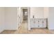 Bright hallway with wood-look flooring and white walls at 10330 E Jewell Ave # 67, Aurora, CO 80247