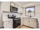 Modern kitchen with white cabinets, stainless steel appliances, and subway tile backsplash at 10330 E Jewell Ave # 67, Aurora, CO 80247