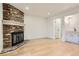 Living room with brick fireplace and wood-look flooring at 10330 E Jewell Ave # 67, Aurora, CO 80247