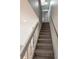 Bright staircase featuring neutral carpeting and white railings leading to the upper level at 10330 E Jewell Ave # 67, Aurora, CO 80247