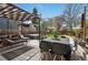 Outdoor living space with dining table, hot tub and pergola for relaxing in a backyard setting at 1141 Adams St, Denver, CO 80206
