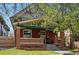 Charming brick home with a welcoming front porch and mature landscaping at 1141 Adams St, Denver, CO 80206