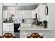 Charming kitchen with white cabinetry, marble countertops, and modern appliances at 1141 Adams St, Denver, CO 80206