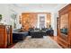 Spacious living room with exposed brick wall, hardwood floors, and a cozy atmosphere at 1141 Adams St, Denver, CO 80206