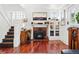Living room featuring hardwood floors, a fireplace, and access to the upper level at 1141 Adams St, Denver, CO 80206