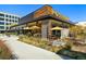 POSTINO restaurant featuring a modern design with outdoor seating and manicured landscaping at 1141 Adams St, Denver, CO 80206