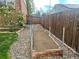 Fenced backyard with garden bed and stone landscaping at 7906 W Walker Dr, Littleton, CO 80123