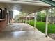 Covered backyard patio and well-manicured green lawn at 7906 W Walker Dr, Littleton, CO 80123