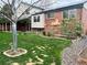 Brick home with landscaped backyard and covered patio at 7906 W Walker Dr, Littleton, CO 80123