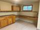 Basement with custom cabinets, countertop, and tiled flooring at 7906 W Walker Dr, Littleton, CO 80123