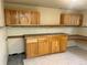 Basement with custom cabinets, countertop, and tiled flooring at 7906 W Walker Dr, Littleton, CO 80123