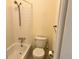 Standard bathroom featuring a tub, shower, and toilet with a yellow wall color at 7906 W Walker Dr, Littleton, CO 80123