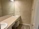 Bathroom featuring dual sinks, vanity, and patterned wall coverings at 7906 W Walker Dr, Littleton, CO 80123