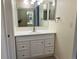 Neutral bathroom with a single sink vanity, large mirror, and tiled flooring at 7906 W Walker Dr, Littleton, CO 80123