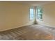 Spacious bedroom with neutral walls and carpet, and double-hung windows at 7906 W Walker Dr, Littleton, CO 80123