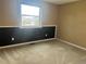 Bedroom with a large window and neutral carpet, showing a view of the neighborhood at 7906 W Walker Dr, Littleton, CO 80123