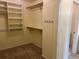 Walk-in closet with built-in shelving and carpet at 7906 W Walker Dr, Littleton, CO 80123