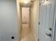 Hallway with tiled flooring and access to multiple rooms at 7906 W Walker Dr, Littleton, CO 80123