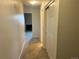 Hallway with carpeted floor leading to various rooms with closet featuring sliding doors at 7906 W Walker Dr, Littleton, CO 80123