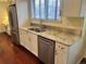 Kitchen features stainless steel appliances, including dishwasher and refrigerator, and a double sink with designer faucet at 7906 W Walker Dr, Littleton, CO 80123