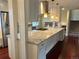 Spacious kitchen with a center island, cooktop, modern appliances, hardwood floors and plenty of storage at 7906 W Walker Dr, Littleton, CO 80123