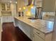 Bright and spacious kitchen with an oversized island, stainless appliances, and white cabinetry at 7906 W Walker Dr, Littleton, CO 80123
