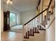 Cozy living room with staircase and views to exterior foliage at 7906 W Walker Dr, Littleton, CO 80123