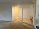 Open-concept living room with tiled entryway and neutral carpet at 7906 W Walker Dr, Littleton, CO 80123