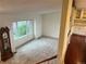 Open-concept living room with large window and hardwood floors leading to the kitchen at 7906 W Walker Dr, Littleton, CO 80123