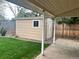 Backyard shed with covered patio on manicured lawn at 7906 W Walker Dr, Littleton, CO 80123
