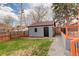 Backyard with small gray garage/shed, gravel walkway, and small grass area at 2568 Clermont St, Denver, CO 80207