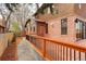 Backyard patio area featuring brick house, wood deck and gravel walkway at 2568 Clermont St, Denver, CO 80207