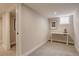 Finished basement with carpeted floor, bright lighting, and featuring a work-from-home office area with a desk at 2568 Clermont St, Denver, CO 80207